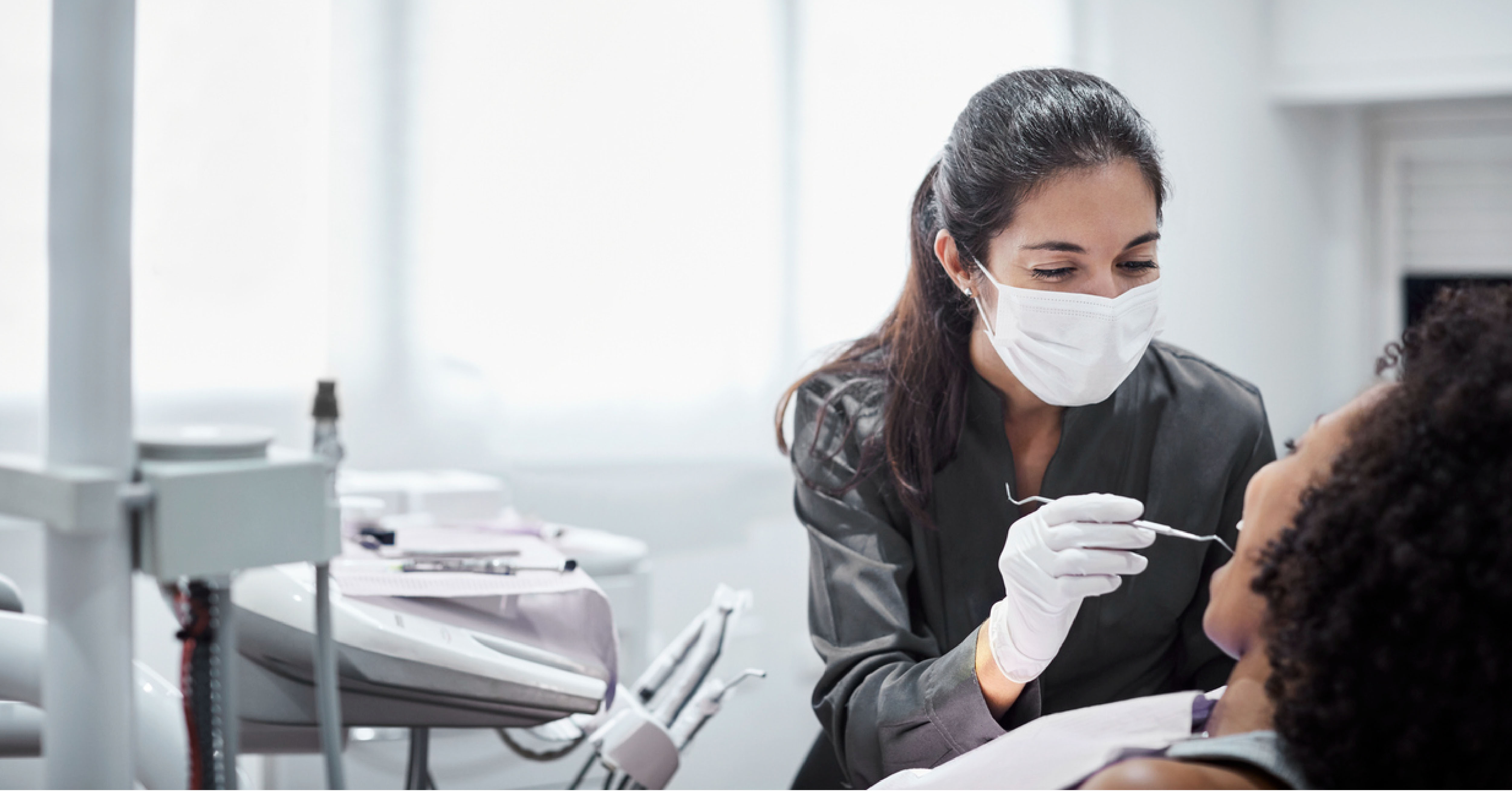 dentist cleaning patient's teeth