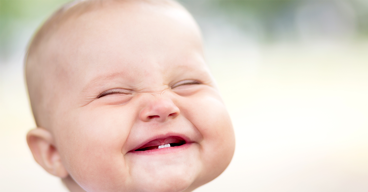 Baby with first teeth ready for dentist